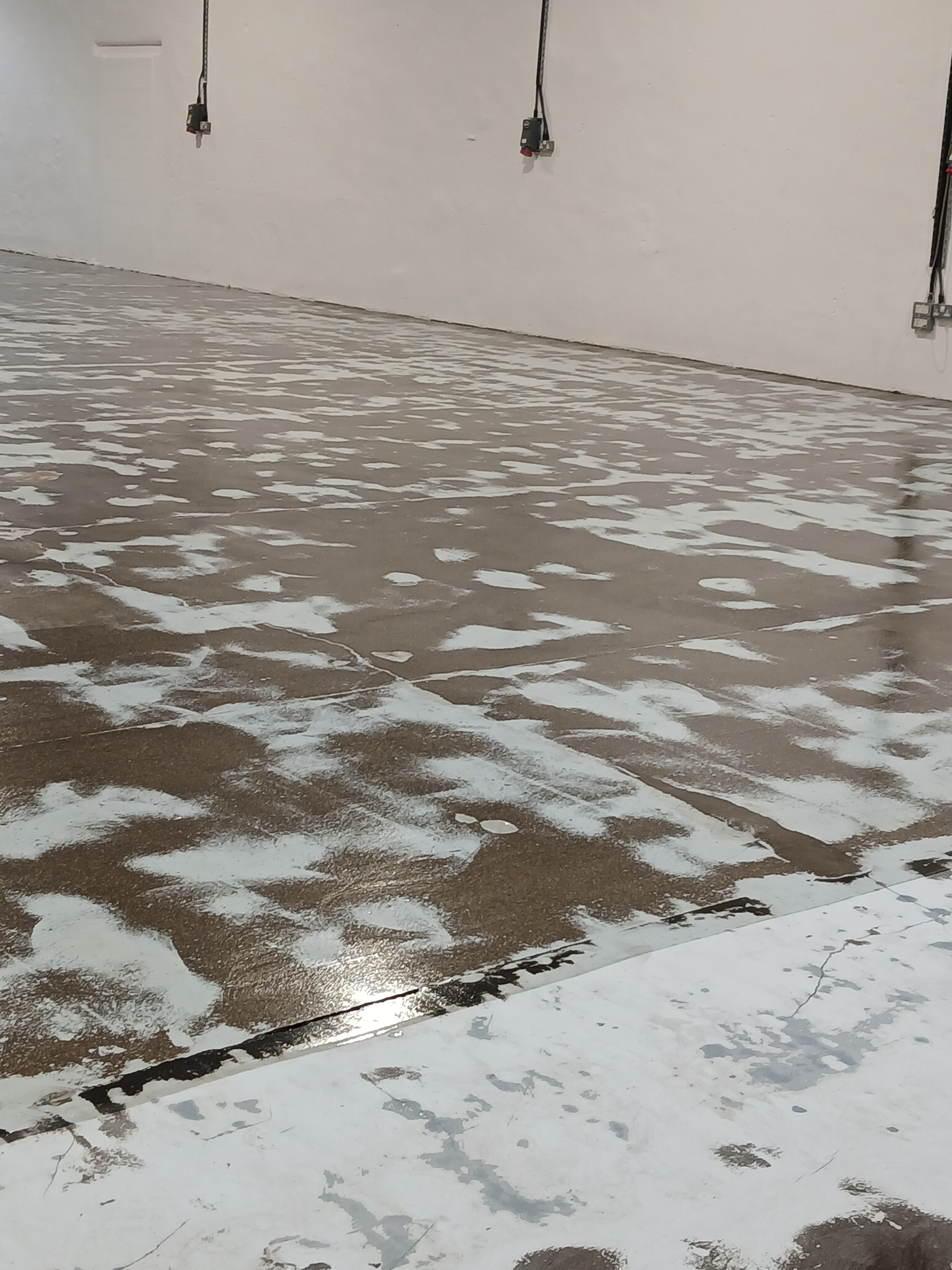 During: shot blasted and primed industrial concrete substrate during epoxy resin floor preparation in the Lake District
